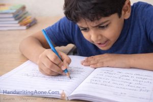 student struggling to write neatly in notebook showing common handwriting problem explained by HandwritingAone.com