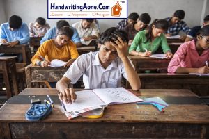 students writing exam in classroom while one student looks worried about exam performance