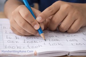 close view of student pencil grip while writing showing handwriting practice problem explained by HandwritingAone.com