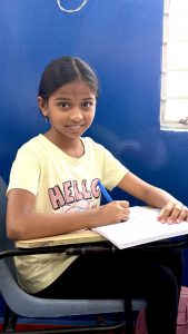 Girl learning neat handwriting at HandwritingAone Bangalore classroom