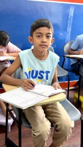 Child practicing cursive handwriting in structured class at Vijayanagar Bangalore