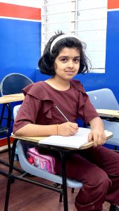 Young student practicing handwriting in classroom at Handwriting Improvement Classes in Vijayanagar Bangalore