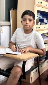 Student practicing neat handwriting in classroom at Vijayanagar Bangalore handwriting classes