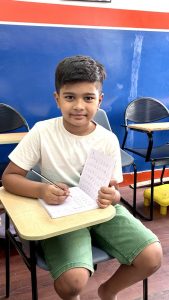 Child learning letter strokes in handwriting workbook Bangalore handwriting course
