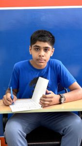 Student practicing neat handwriting with proper grip and posture Bangalore